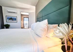 a bedroom with a large bed with white pillows at Tuscany Residence Aruba in Palm-Eagle Beach