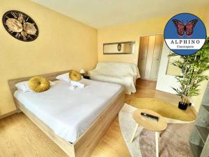 a bedroom with two beds and a butterfly clock on the wall at Le Clémenceau fonctionnel et tout équipé in Limoges