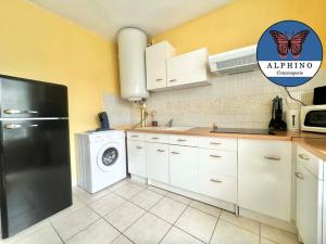 a kitchen with a black refrigerator and a dishwasher at Le Clémenceau fonctionnel et tout équipé in Limoges