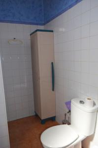 a bathroom with a toilet and a phone on the wall at Casa Sendero de Taidia in San Bartolomé