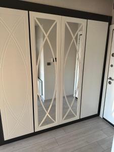 a white closet with glass doors in a room at ÖYKÜM HOME 