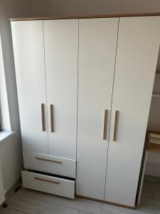 a white cupboard in a room with white cabinets at ÖYKÜM HOME 