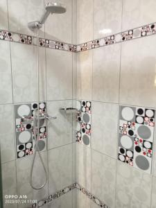 a shower with black and white circles on the wall at Depamia in Huaraz