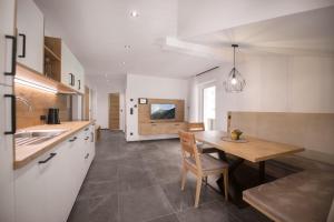 a kitchen with a table and a dining room at Living Miramor in Racines
