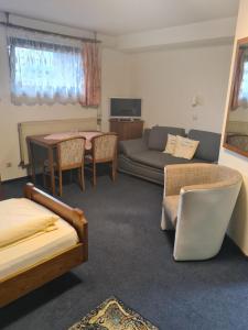 a living room with a couch and a table at Gästehaus Weber in Rodgau