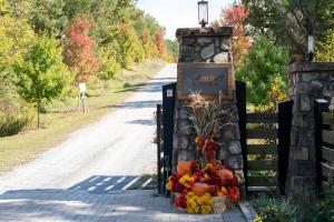 a gate with a sign that reads harvard cemetery on a road at Juneberry Ridge in Norwood +4 photos