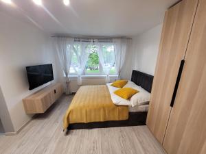 A bed or beds in a room at Apartament Zabrze Grzybowska