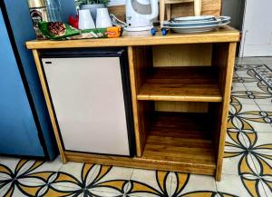 a small wooden cabinet with a whiteboard in a kitchen at Townhouse 88 cloudy room in Sliema