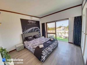 a bedroom with a zebra print bed and a large window at HIMALAYA ROOFTOP Sea VIEW in Albufeira +59 photos