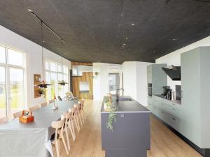 a large kitchen with a large island in a room at 12 person holiday home in Vinderup-By Traum in Vinderup +25 photos