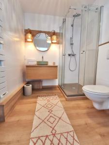 a bathroom with a shower and a toilet and a sink at Vue sur mer La Baule Clara in La Baule