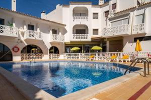 a swimming pool in front of a building at HIMALAYA ROOFTOP Sea VIEW in Albufeira
