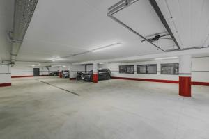 an empty parking garage with cars parked in it at Hotel Rosa Wellness & SPA in Vigo di Fassa