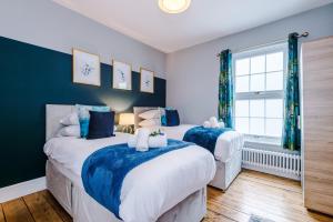 two beds in a bedroom with blue and white at NEW! Gorgeous 2-bed home in Chester City Centre by 53 Degrees Property - Incredible location, Ideal for Small Groups - Sleeps 6! in Chester