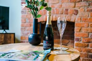 a bottle of champagne and a wine glass on a table at NEW! Gorgeous 2-bed home in Chester City Centre by 53 Degrees Property - Incredible location, Ideal for Small Groups - Sleeps 6! in Chester
