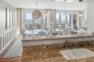 a kitchen and dining room with a table and chairs at BEAUTIFUL GULF VIEWS Spacious, Updated 316B WaterSound Crossings Steps to Beach and Pool condo in Panama City Beach +14 photos
