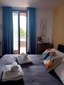 a hotel room with two beds with towels on them at Albergo ai Sapori in San Daniele del Friuli