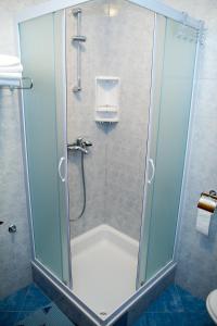 a shower with a glass door in a bathroom at Villa Magnolija in Mlini