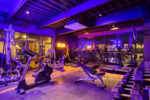 a gym with several tread machines in a room at Downtown Designer Apartments by ULIV in Tijuana