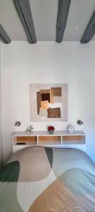 a bedroom with a bed and a white wall at Appartement de charme au cœur de la vieille ville in Annecy