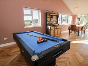 a living room with a pool table in it at Hardhills Cottage in Castle Douglas