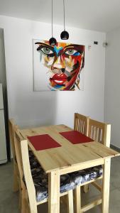a wooden table with chairs and a painting on the wall at Epic Playa Unión 4 in Playa Unión +8 photos