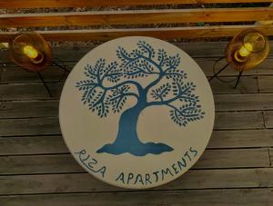 a plate with a tree painted on it on a table at Riza Apartments in Kardamili