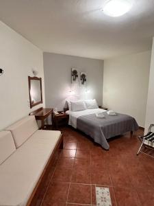 A bed or beds in a room at Iolkos Hotel Apartments