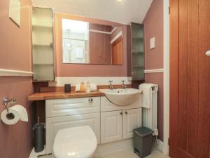 a bathroom with a sink and a toilet at Inglenook Cottage in Guisborough +25 photos