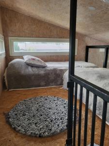 a bedroom with two beds and a window at Mini house Imatra with own garden in Imatra