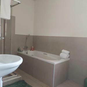 a bathroom with a bath tub and a sink at Cozy Stay in Windhoek