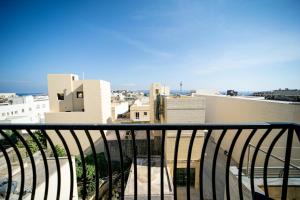 a view of a city from a balcony at 49 Sunrise Lodge in Għajnsielem