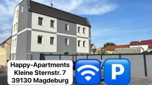 a building with two blue signs in front of it at Happy -Apartments in Magdeburg