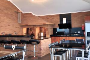 a restaurant with tables and chairs and a fireplace at Casa Da Achada, By OP in São Vicente