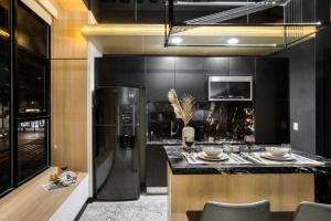 a kitchen with a black refrigerator and a counter at Downtown Designer Apartments by ULIV in Tijuana