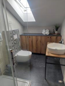 a bathroom with a toilet and a sink and a shower at COMFORT Suites VELIKA GORICA in Velika Gorica +38 photos
