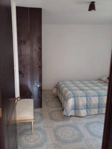 Un dormitorio con una cama y una silla dentro. en CASA ACOGEDORA, en Chignahuapan