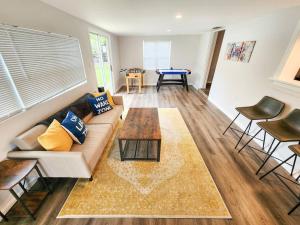 a living room with a couch and a table at Astor River House with 2 private boat slips in Astor