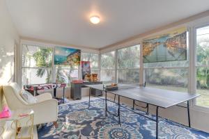 a room with a ping pong table and some windows at Largo House with Backyard Oasis and Proximity to Beach in Largo