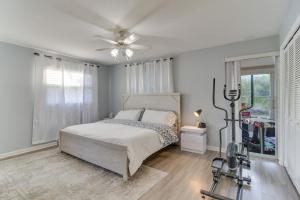 a bedroom with a bed and a ceiling fan at Largo House with Backyard Oasis and Proximity to Beach in Largo