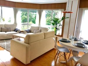 a living room with a couch and a table at Increíbles vistas *CENTRO* in Pontevedra