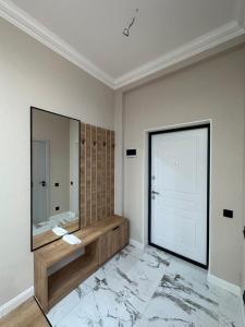 a bathroom with a large mirror and a sink at Freedom hotel in Almaty +17 photos