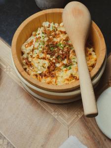 a bowl of food on a table with a wooden spoon at Das Johann in Stuben am Arlberg