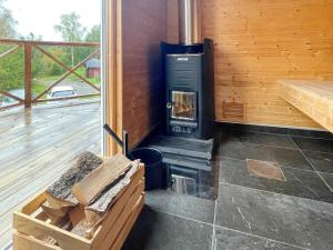 a room with a woodburning stove in a cabin at 4 star holiday home in Hok-By Traum in Hok