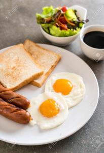 un plato de huevos y tostadas y un tazón de ensalada en Cozy Place-Laid Back, en Mississauga