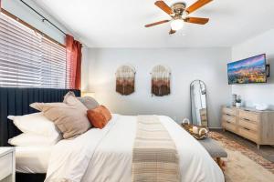 a bedroom with a bed and a ceiling fan at Pool -Hot Tub - Game Room - BBQ in Tempe