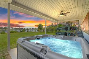 a hot tub on the patio of a house at Nautical Nirvana-Waterfront Joys from Sunrise Paddles to Hot Tub Sunsets in Panama City