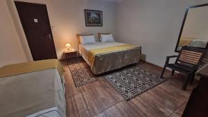 Ліжко або ліжка в номері Hotel Estância