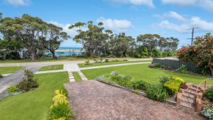 an image of a garden with the ocean in the background at Marlo at the Beach in Marlo