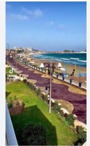 a view of a beach with people and the ocean at LARA Maamoura beach Alexandria in Alexandria